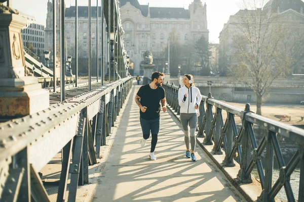 depositphotos_211950570-stock-photo-young-couple-running-urban-enviroment